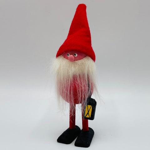 Hand made Tomte with red hat carrying a lantern