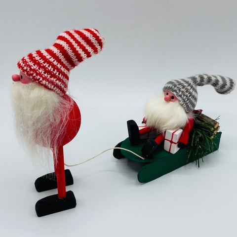 Hand made Tomte with sleigh carrying a tomte, gifts and logs