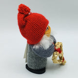 Swedish tomte girl with face mask holding straw heart