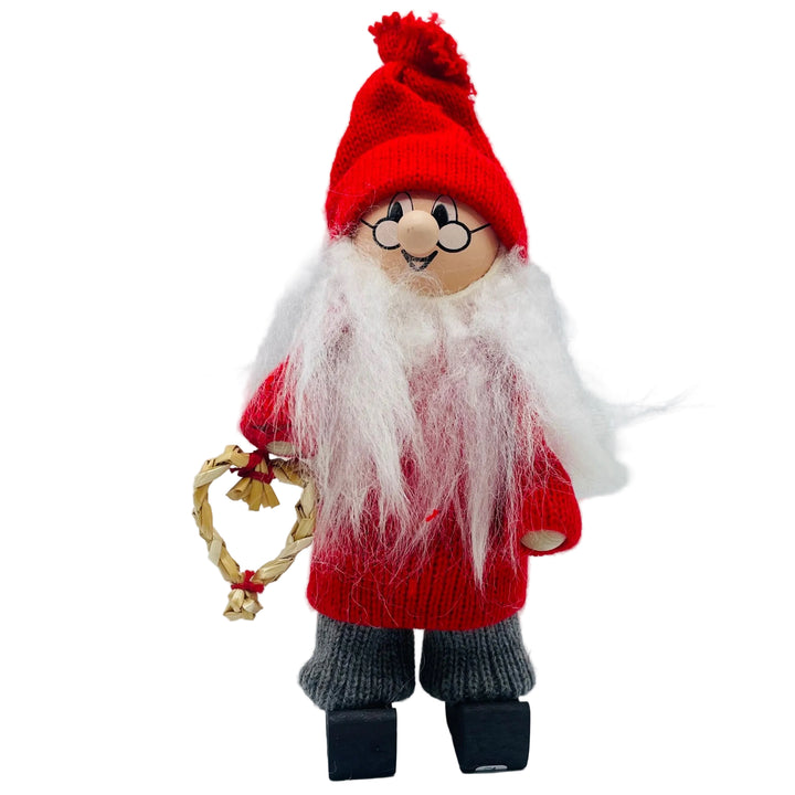 Swedish tomte man holding a straw heart