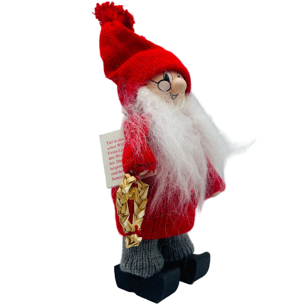 Swedish tomte man holding a straw heart