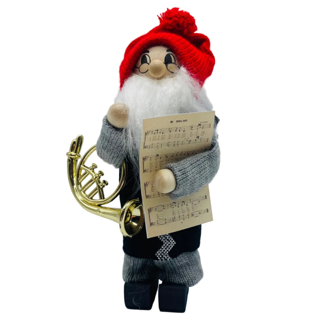 Swedish tomte with French horn and sheet of music