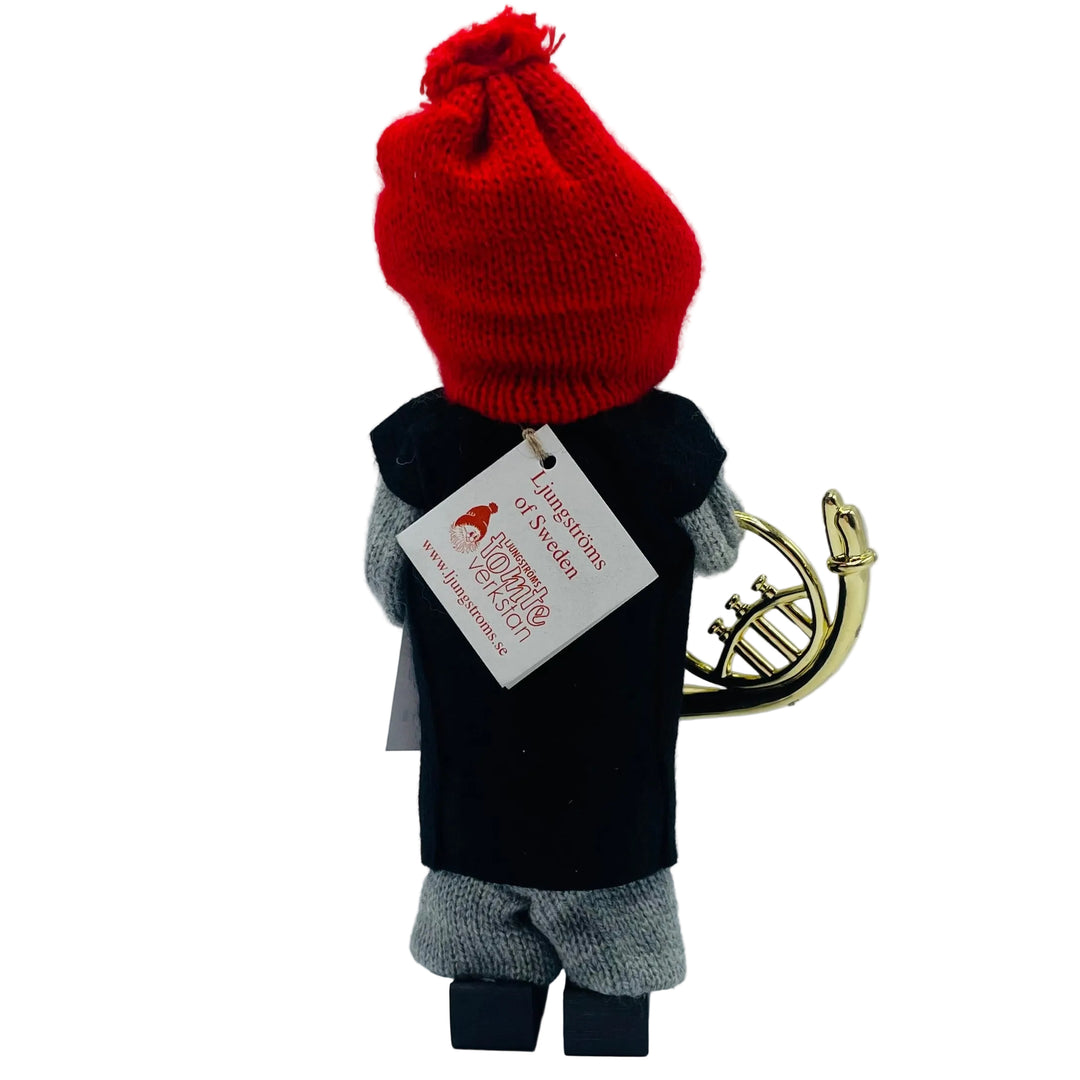 Swedish tomte with French horn and sheet of music
