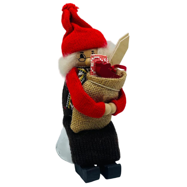 Swedish tomte lady sitting holding a sack of gifts