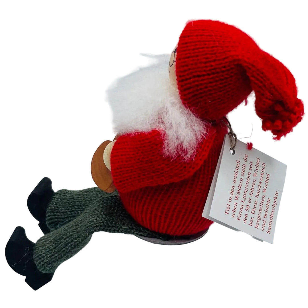 Swedish tomte holding heart cookie