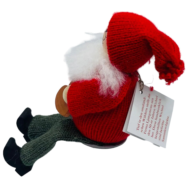 Swedish tomte holding heart cookie