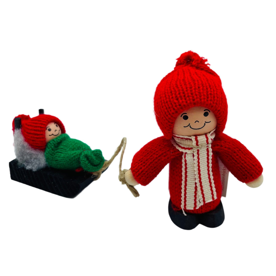 Swedish tomte pulling baby tomte on sled