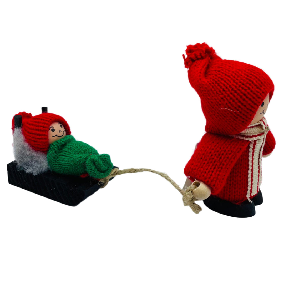 Swedish tomte pulling baby tomte on sled