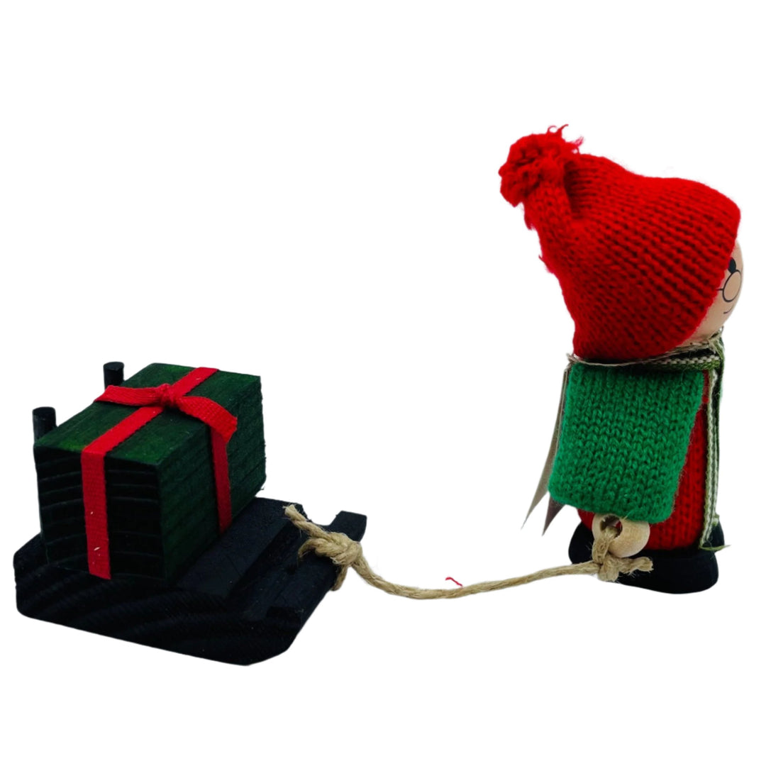 Swedish tomte pulling sled with gift