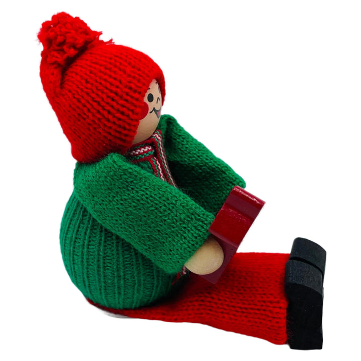 Swedish tomte sitting holding a Dala horse