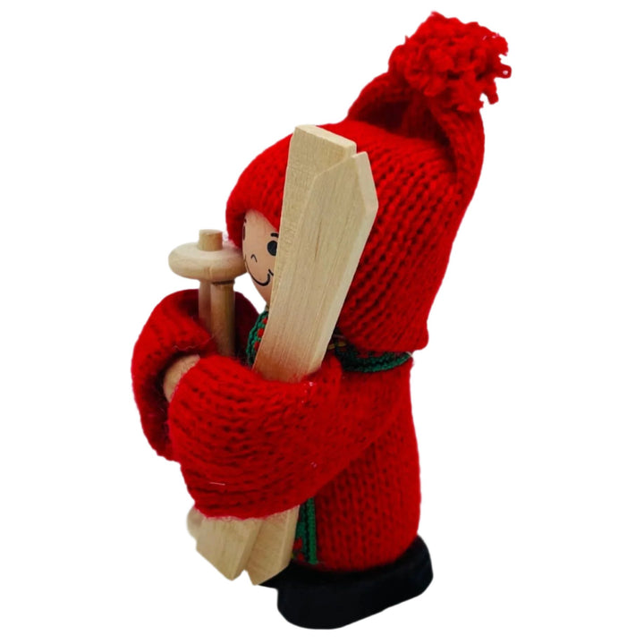 Swedish tomte holding skis and ski poles