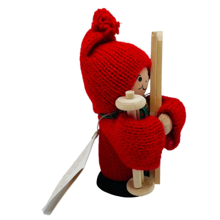 Swedish tomte holding skis and ski poles