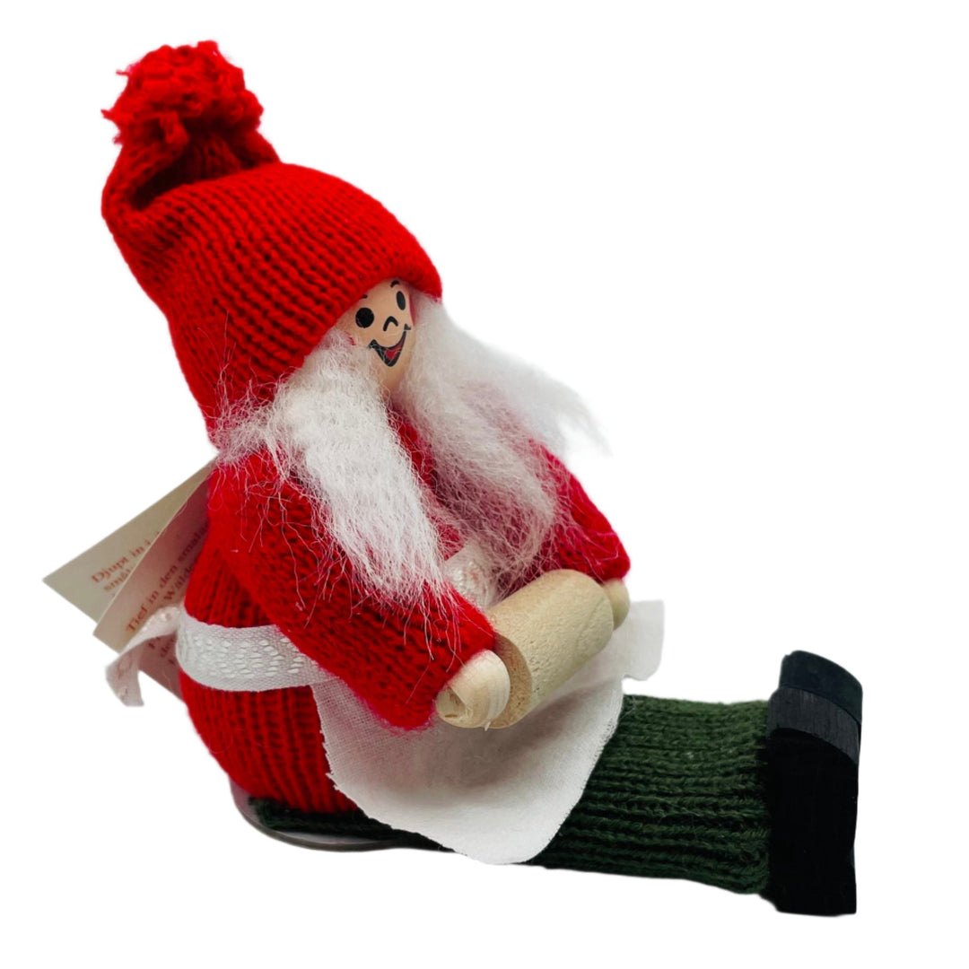 Swedish tomte lady sitting holding rolling pin