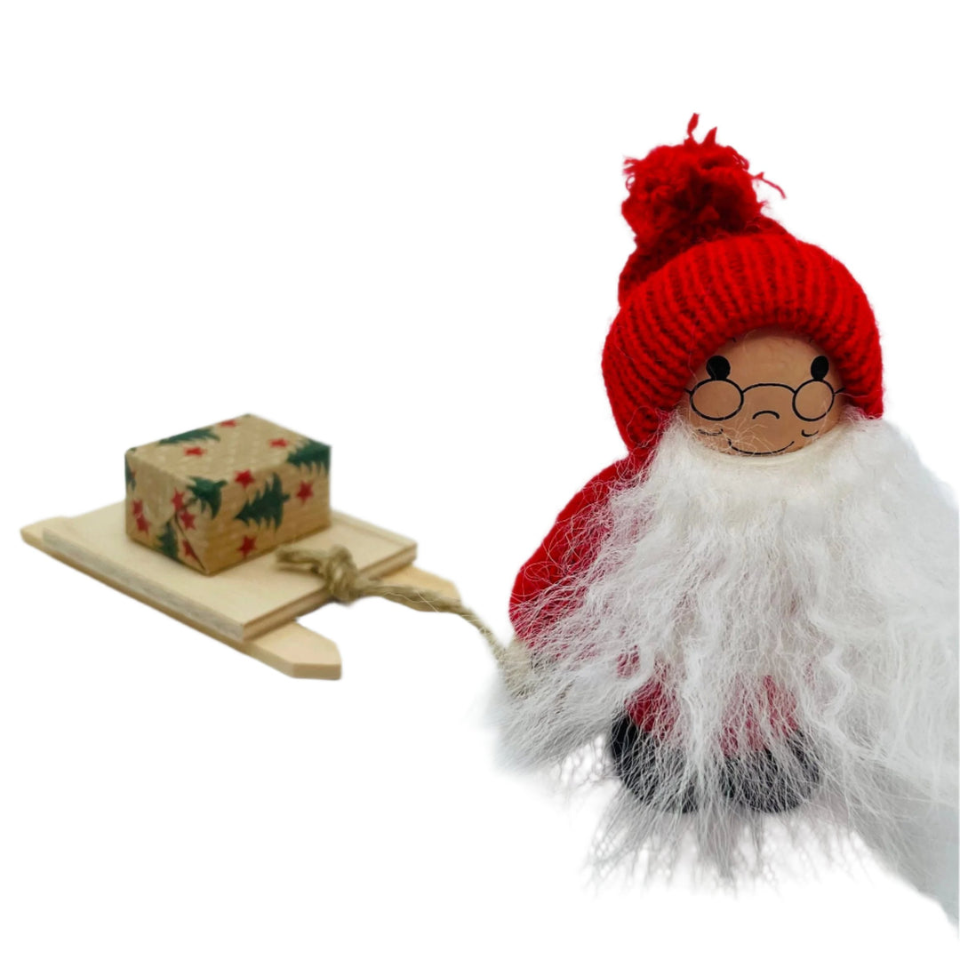 Swedish tomte pulling sled with gift