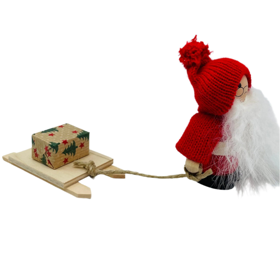 Swedish tomte pulling sled with gift