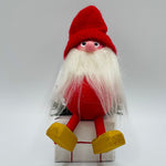 Hand made tomte sitting on gift