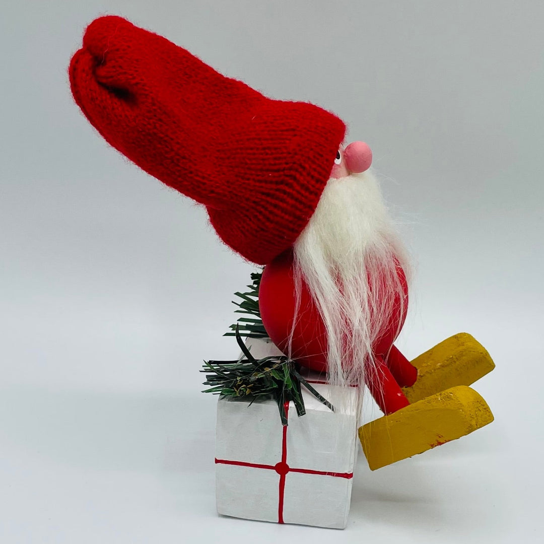 Hand made tomte sitting on gift