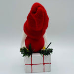 Hand made tomte sitting on gift