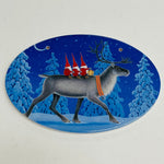 Oval Ceramic Sign - Eva Melhuish Three tomtar riding reindeer