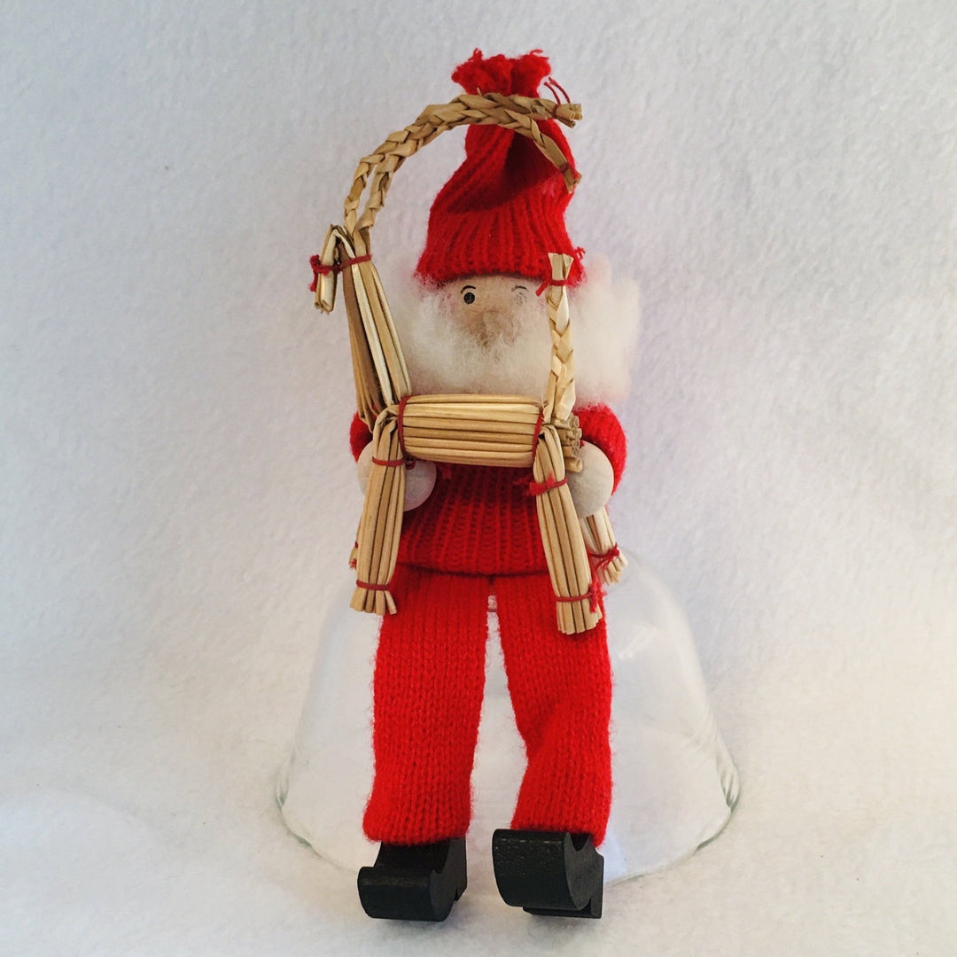 Swedish tomte sitting with straw goat