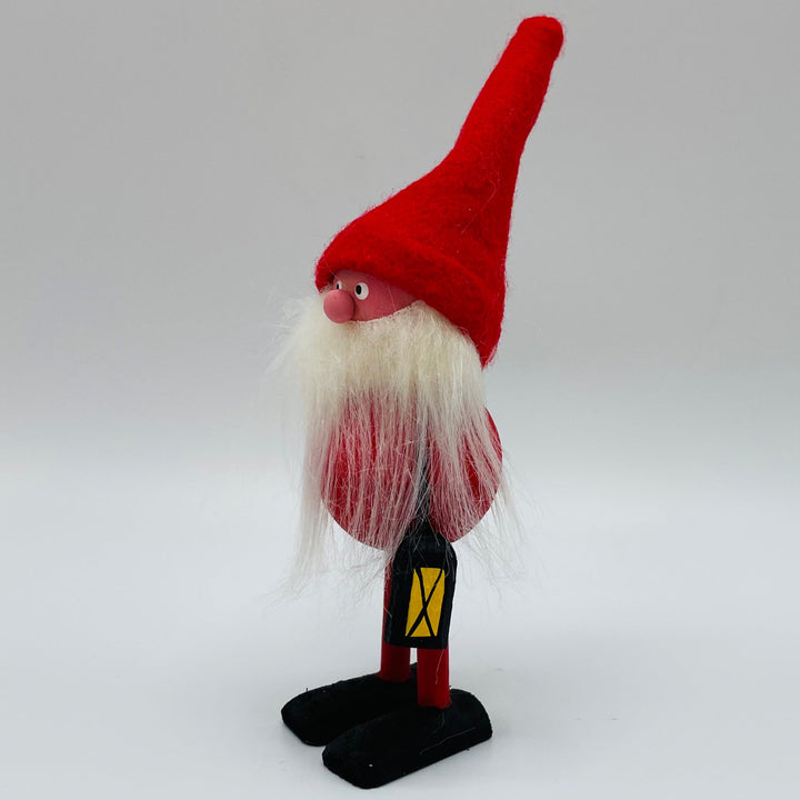 Hand made Tomte with red hat carrying a lantern