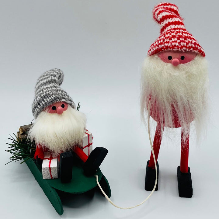 Hand made Tomte with sleigh carrying a tomte, gifts and logs