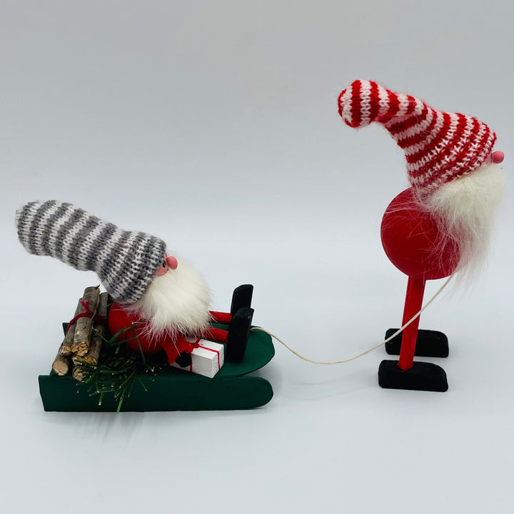 Hand made Tomte with sleigh carrying a tomte, gifts and logs