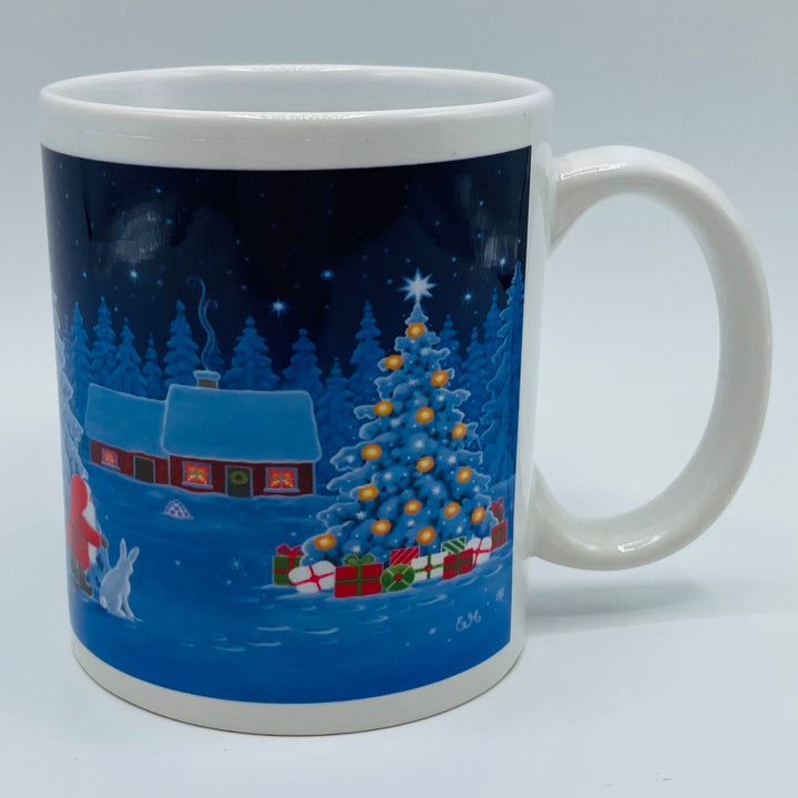 Eva Melhuish Tomte, rabbit & tree at snowy cabin coffee mug