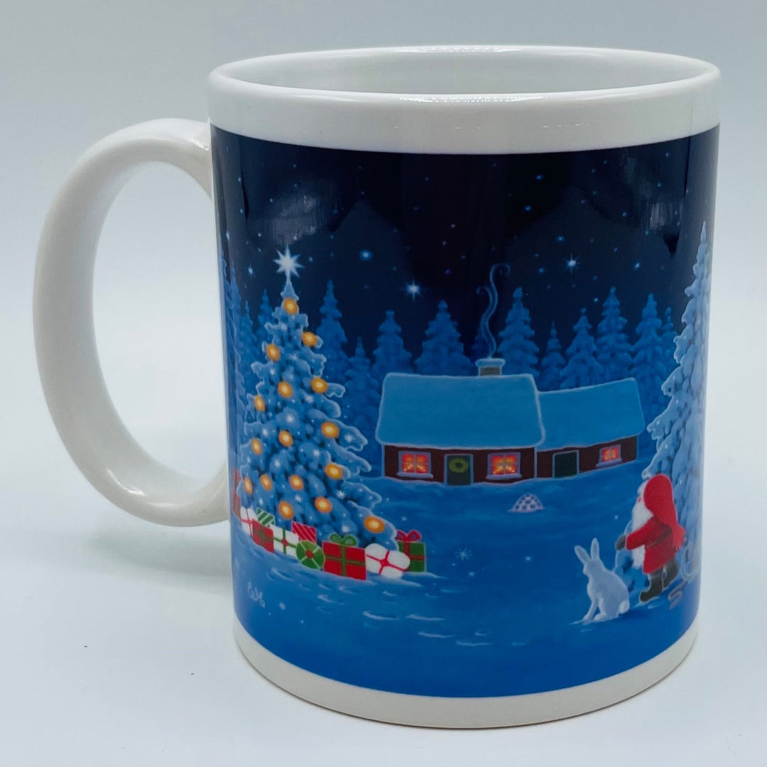 Eva Melhuish Tomte, rabbit & tree at snowy cabin coffee mug