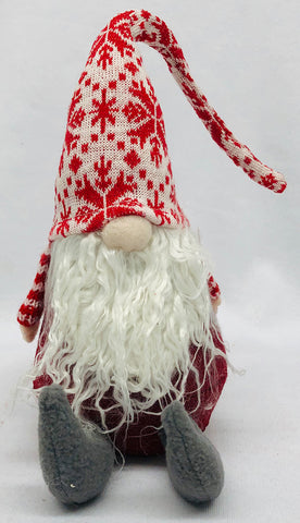 Sitting Nordic gnome with red & white snowflake hat.