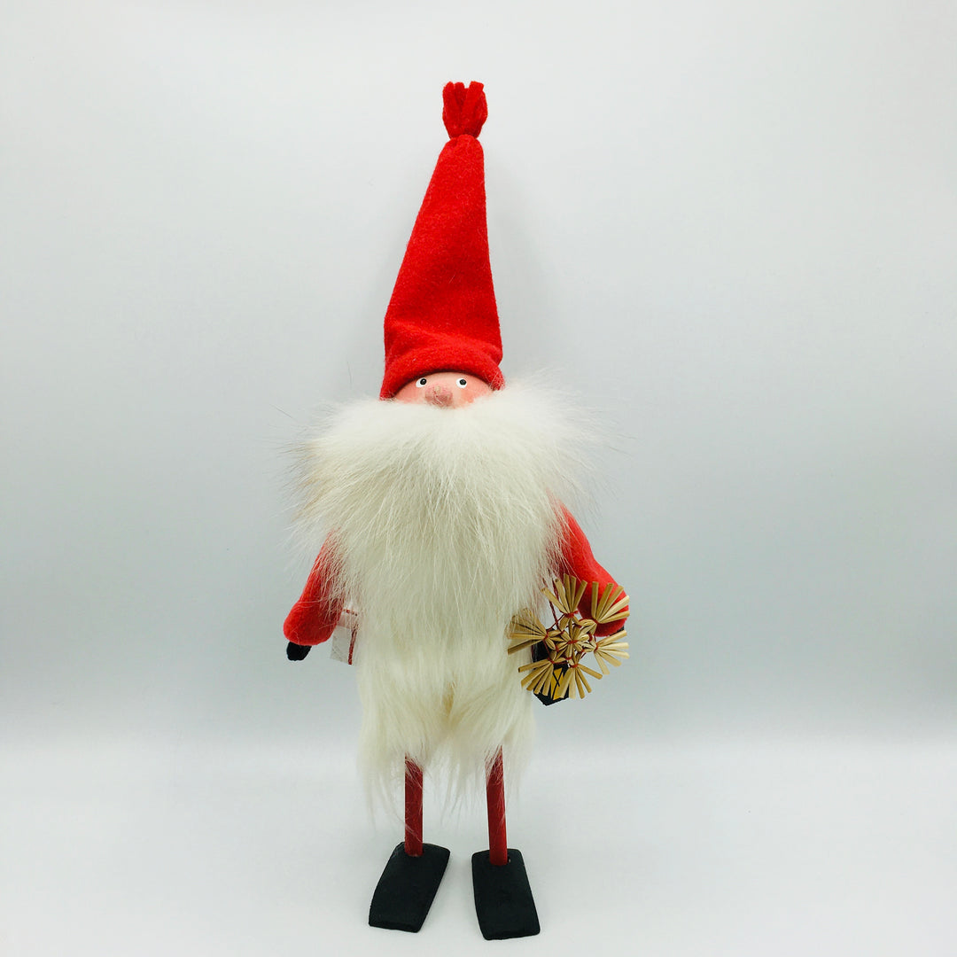 Hand made tomte holding a lantern, snowflake ornament & gift