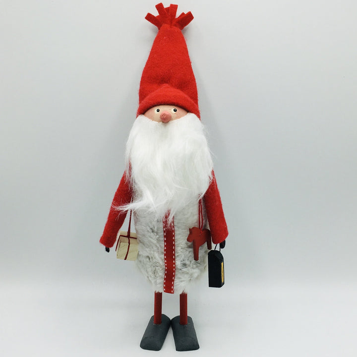 Hand made tomte holding a Dala horse, lantern & gift