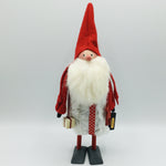 Hand made tomte holding a Dala horse, lantern & gift