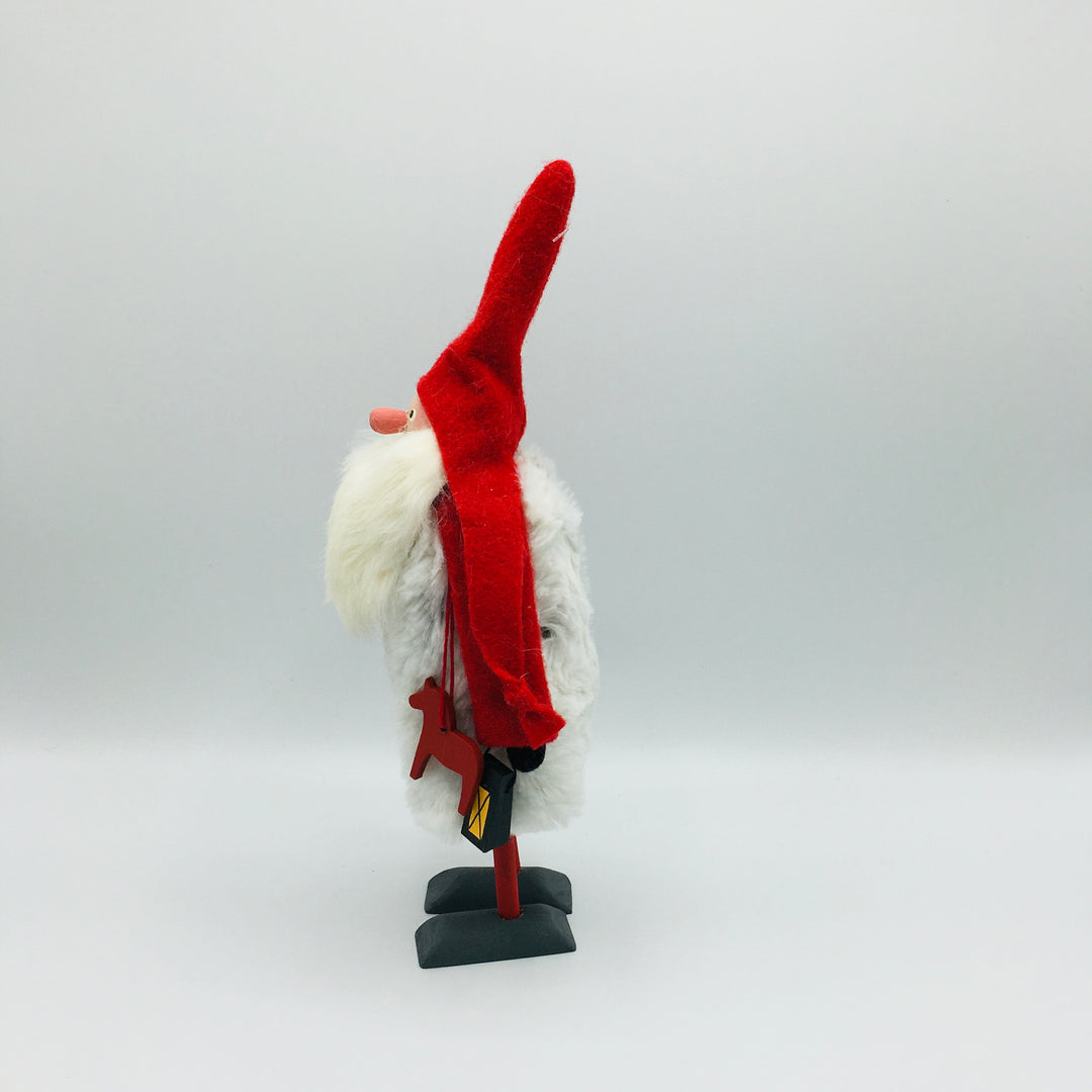 Hand made tomte holding a Dala horse, lantern & gift