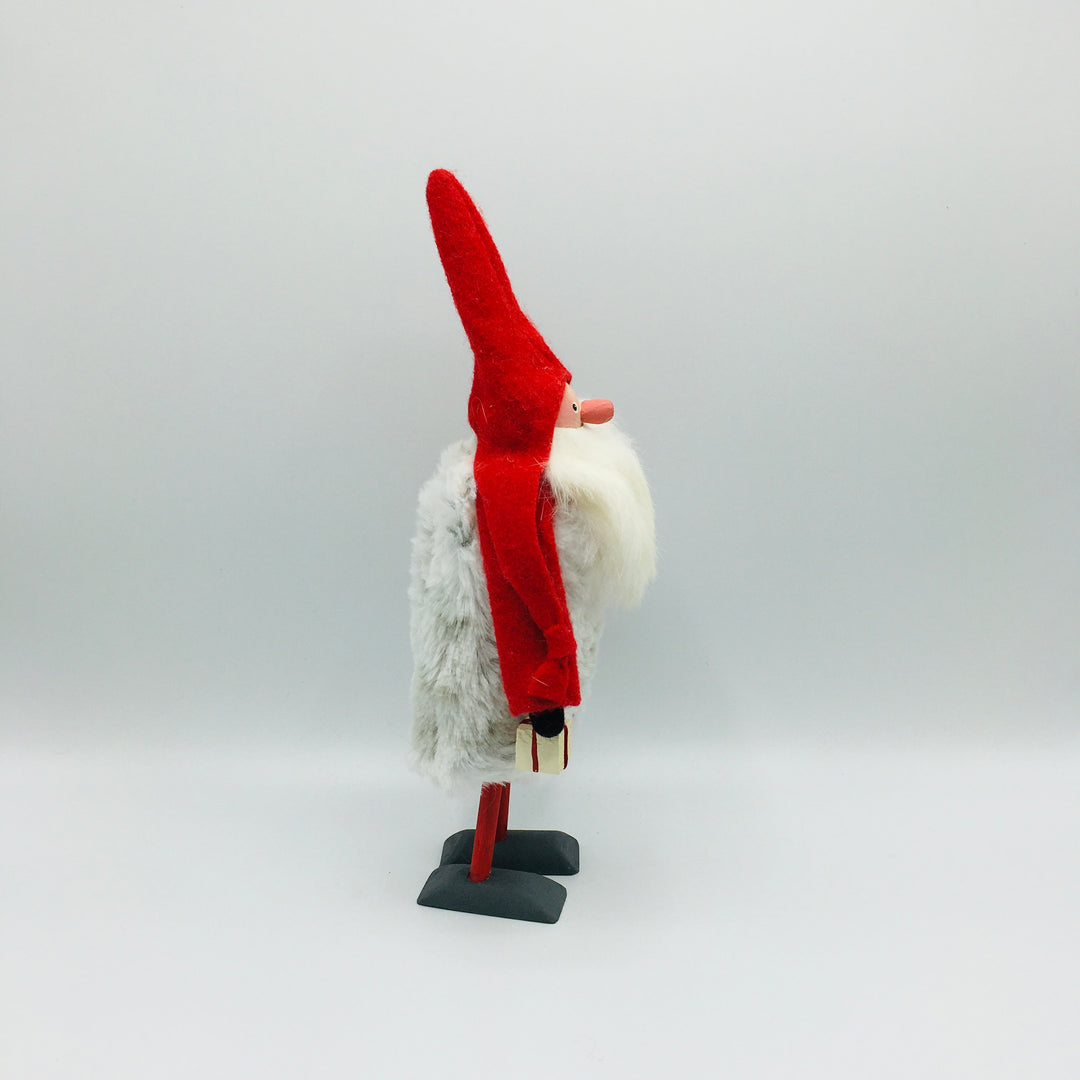 Hand made tomte holding a Dala horse, lantern & gift