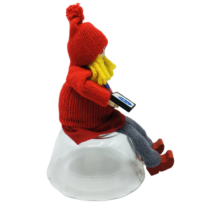 Swedish tomte girl sitting with iPad on Facebook