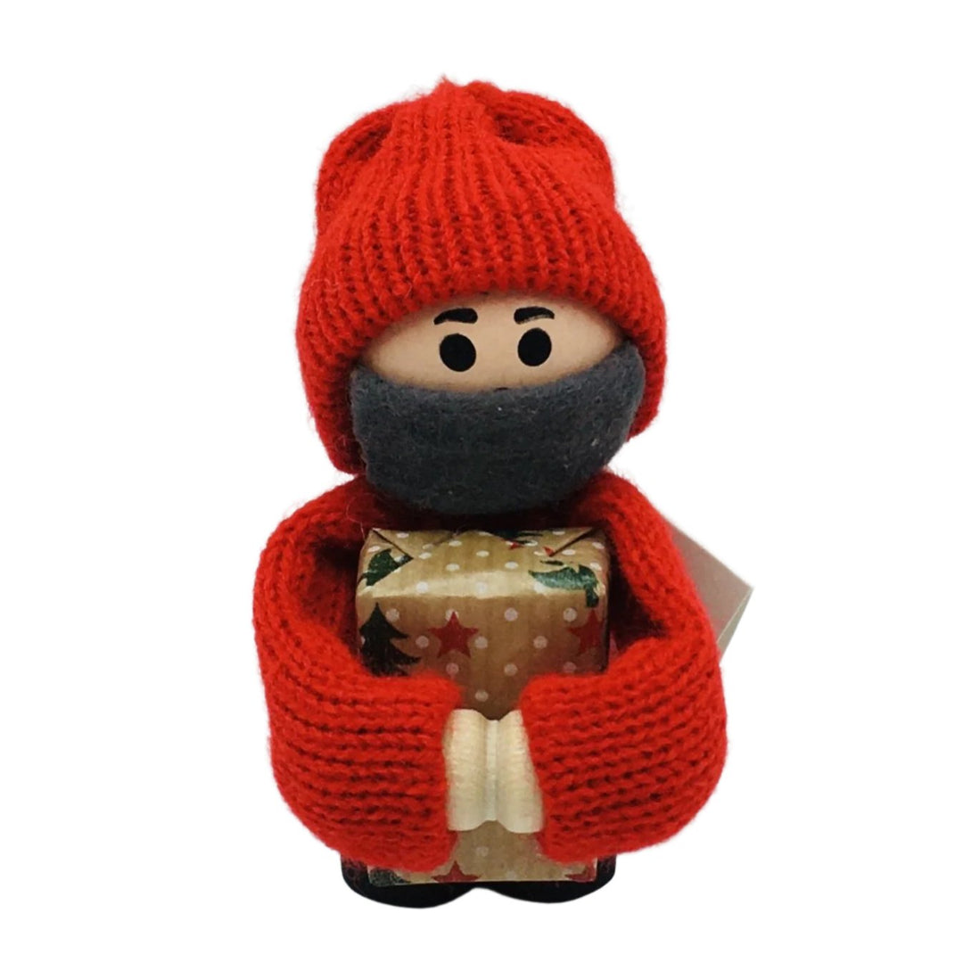 Swedish tomte boy with face mask holding gift