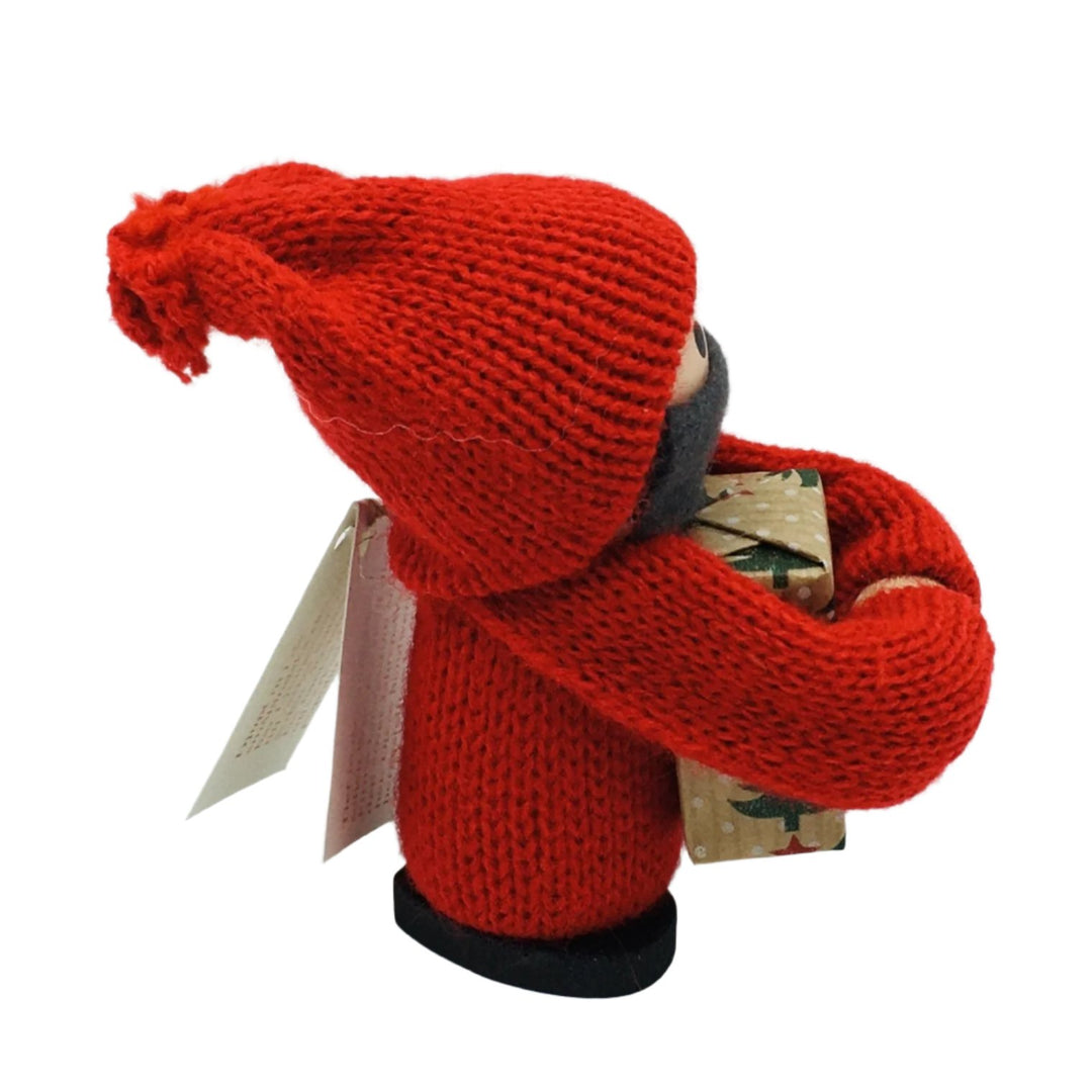 Swedish tomte boy with face mask holding gift