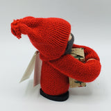 Swedish tomte boy with face mask holding gift