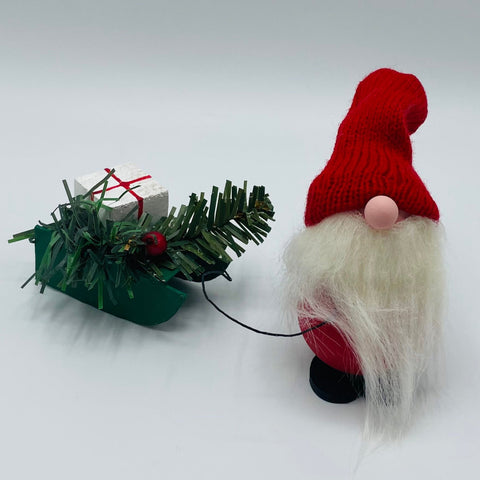 Hand made tomte pulling sled with greenery & gift